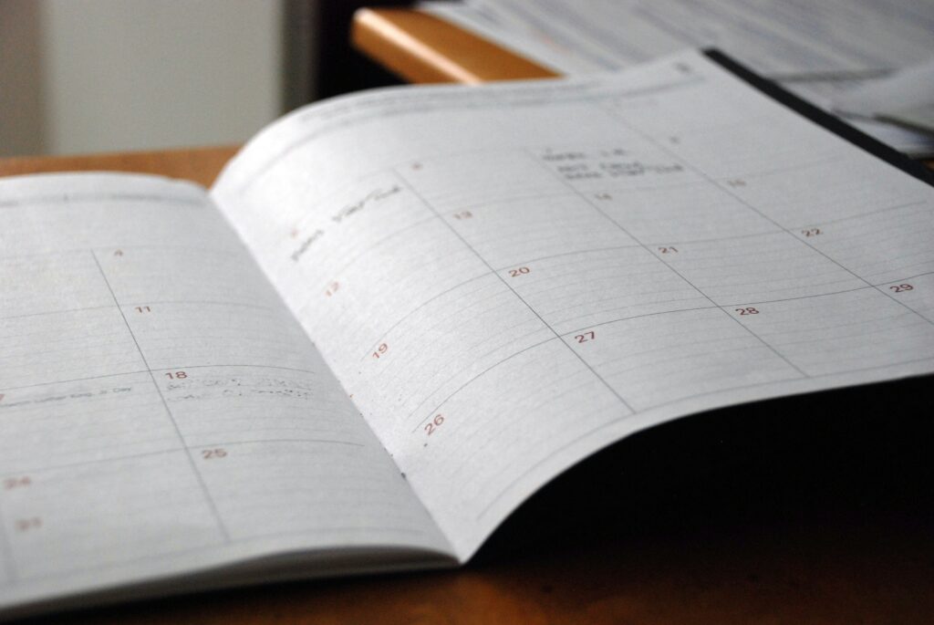 image of calendar in a planner to signal staying on schedule as a benefit of understanding the essential preconstruction considerations of custom home building