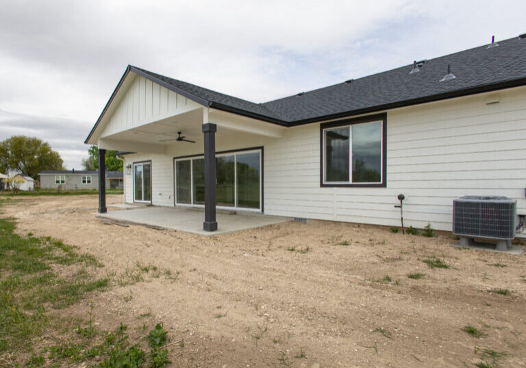 Back exterior with a covered porch on a custom ADU in Nampa - Pathway Builders