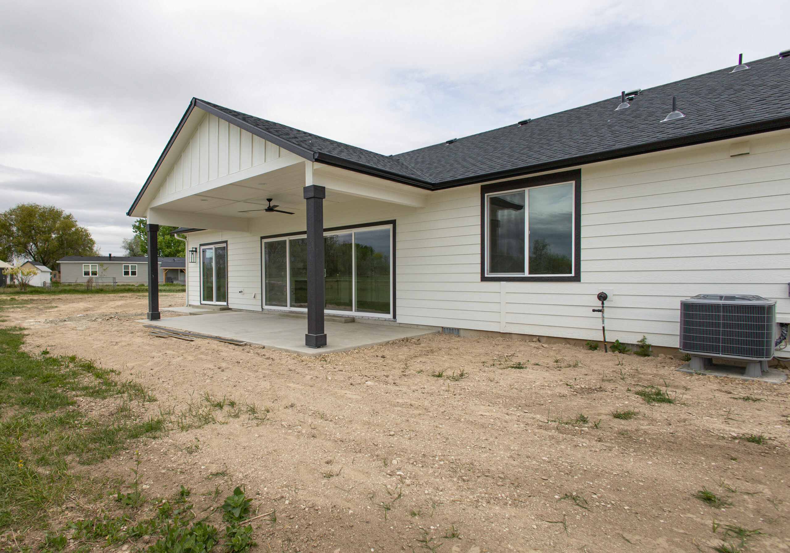 Back exterior with a covered porch on a custom ADU in Nampa - Pathway Builders